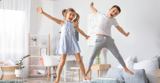 Happy Children Having Fun in Bedroom