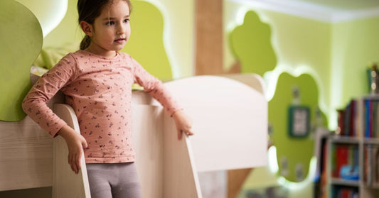 Little girl on a bunk bed